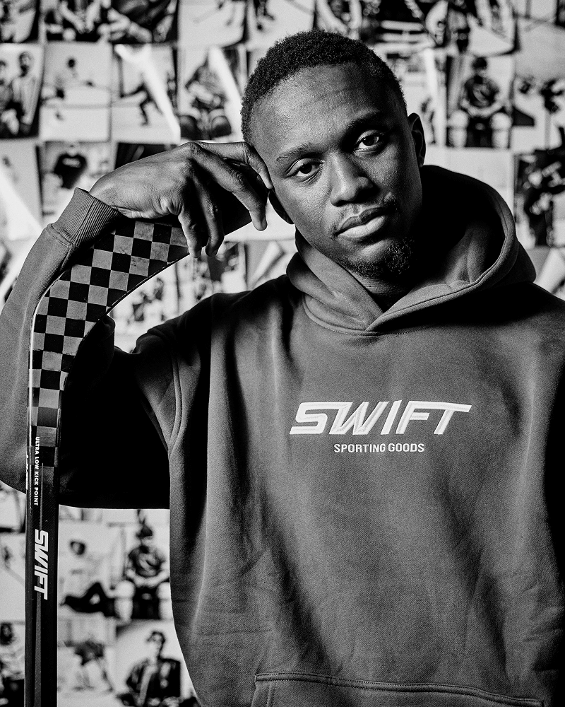 Zecharia Thomas leaning on one of his affordable Swift hockey sticks