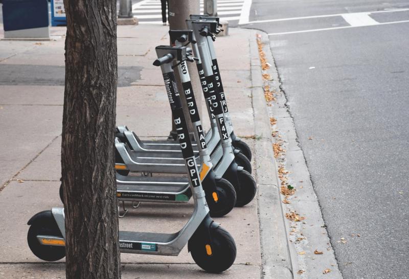 Calgary, Alberta, Canada - August 21, 2021: Bird electric rental scooters lined up on a street