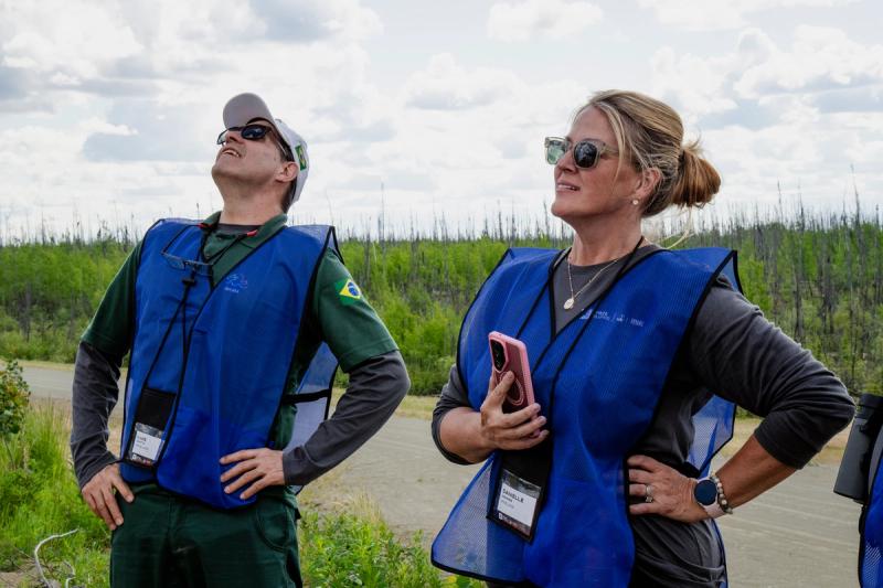 Officials in blue vests watch the sky during Anduril Industriesâ staging day near Nenana, Alaska, on June 18, 2026.