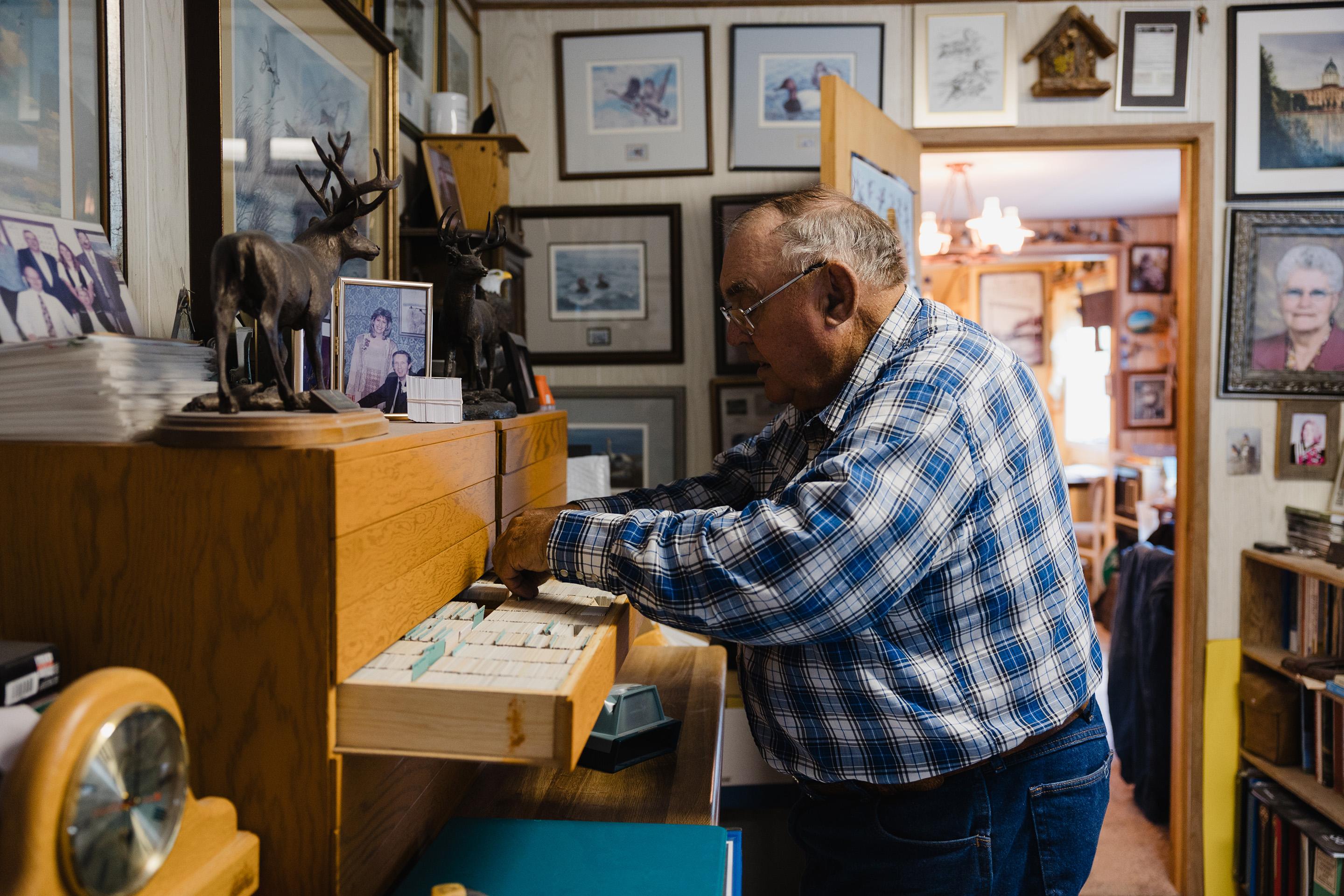 Lorne Scott going through slides of all the plants and birds he documented.