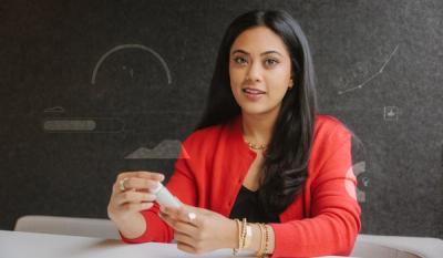 A portrait of Jaiya Varshney, the co-founder and chief operating officer of Tydra Labs, holding a vial of the company's fibrillated chitin