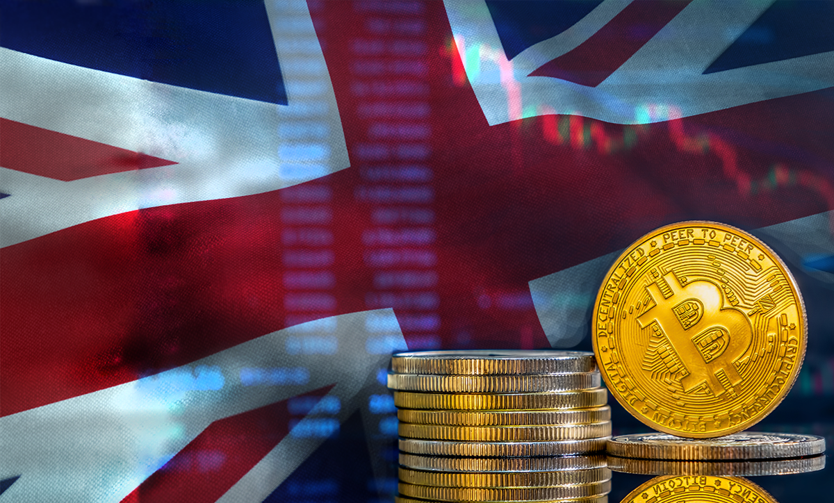 A stack of Bitcoins with the Union Jack behind and a candlestick chart lightly overlayed.