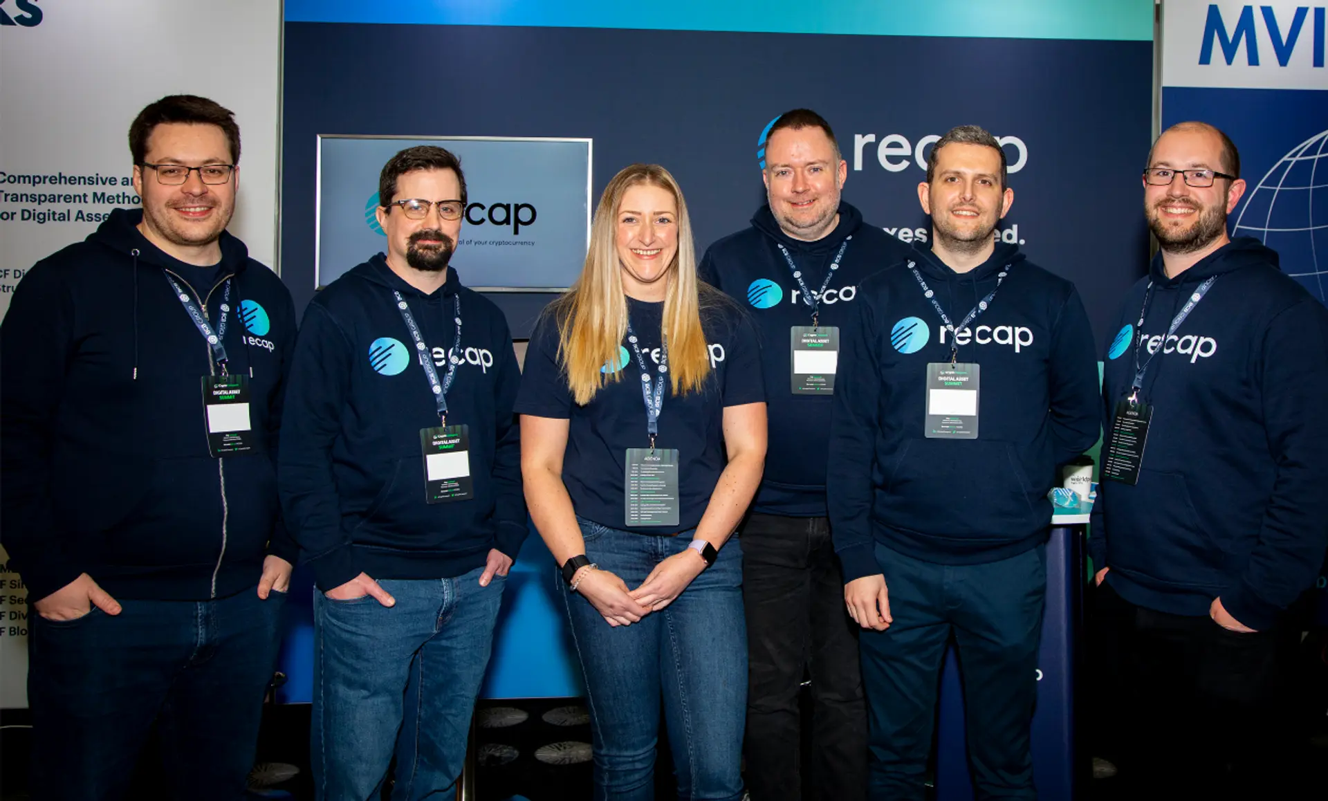 A photograph of the Recap team in front of their stand at The Digital Asset Summit