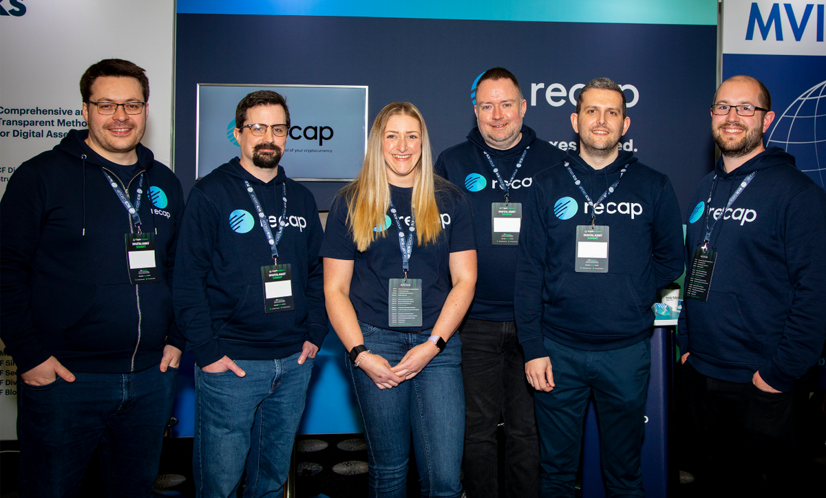 A photograph of the Recap team in front of their stand at The Digital Asset Summit