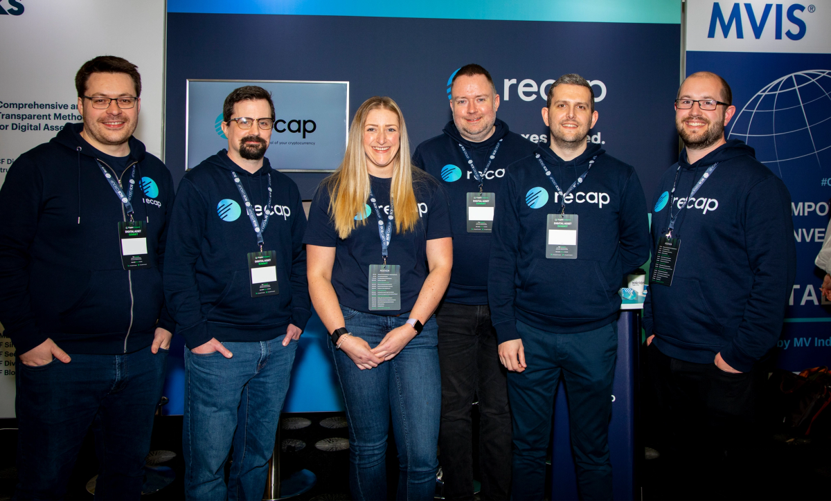 A photograph of the Recap team in front of their stand at The Digital Asset Summit