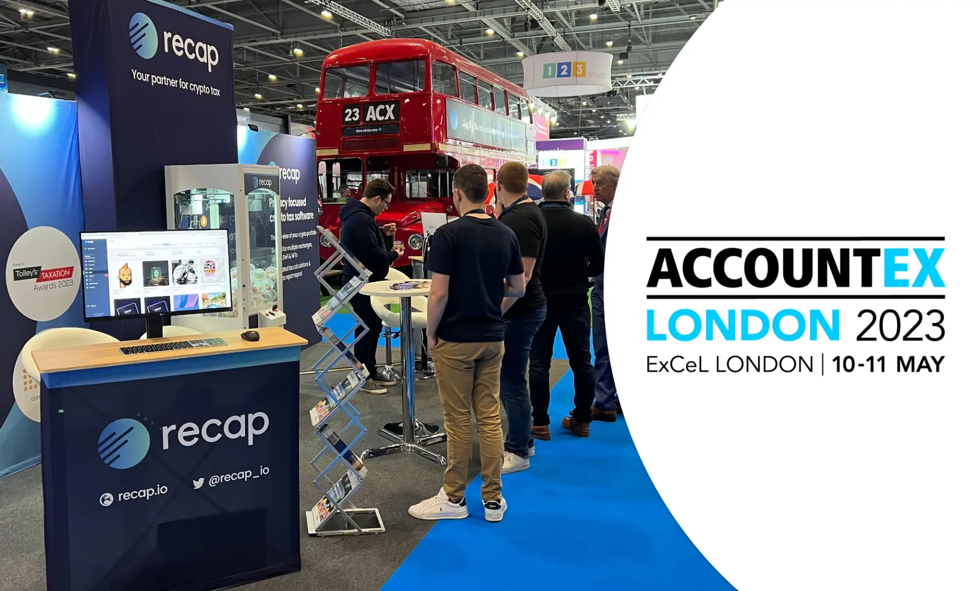 Recap exhibition stand with exhibitors talking to atendees, a London bus numbered 23, destination ACX in the background and an overlay of the Accountex London 2023 logo.