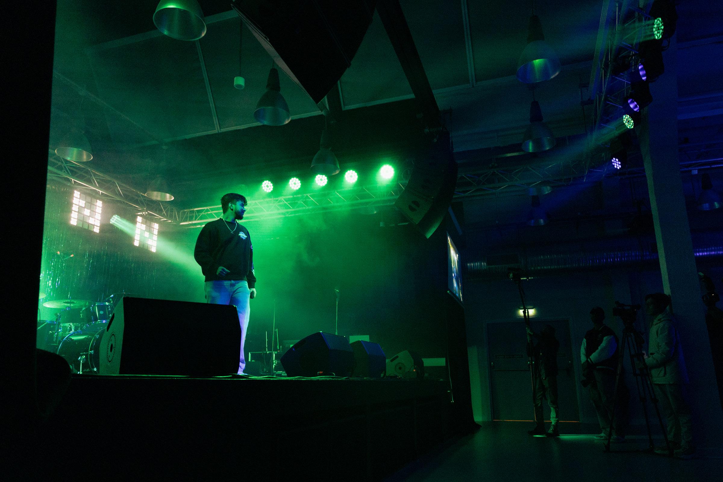 Music student performing on stage at the Area 51 live venue at Harrow campus.