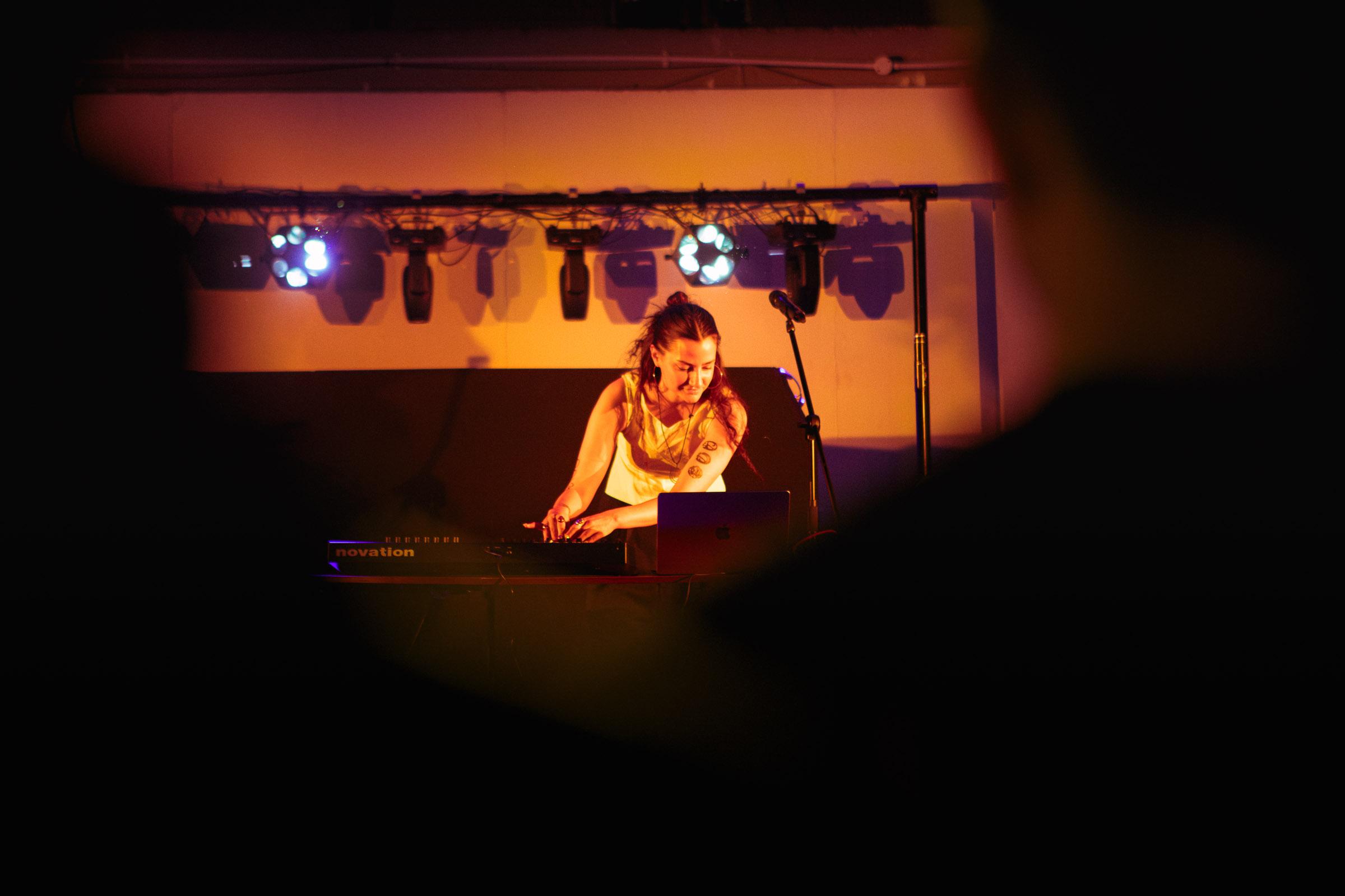 Music student DJing on stage at the Area 51 live venue at Harrow campus.