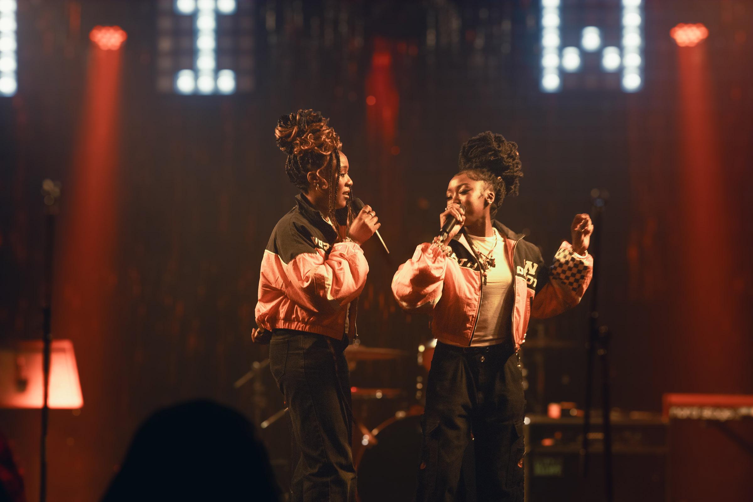 Two female singers performing on stage at the Area 51 live venue at Harrow Campus.