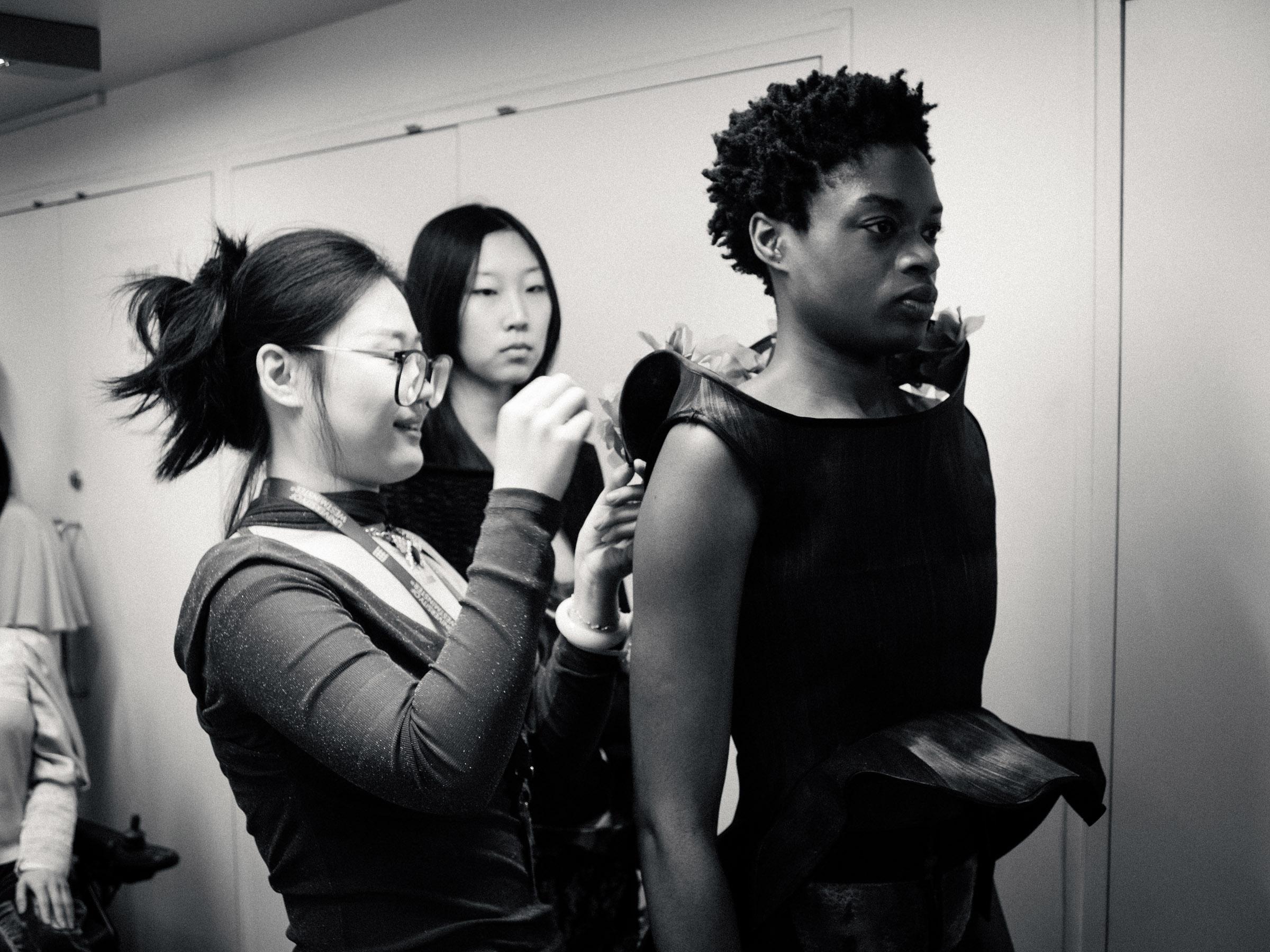 Fashion student fitting a model at Harrow Campus.