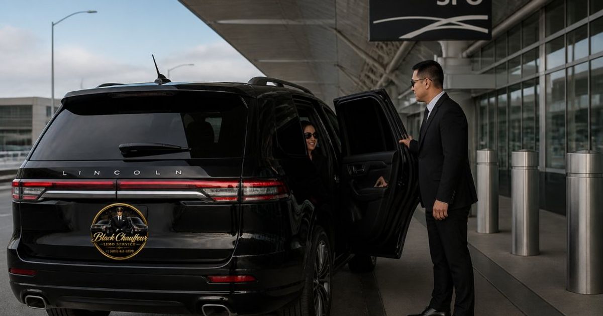 Professional chauffeur assisting a passenger beside a black Lincoln Aviator at San Francisco International Airport (SFO).