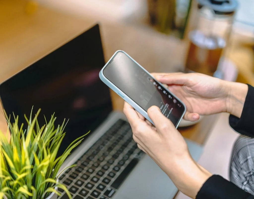 Laptop and mobile phone screen close up