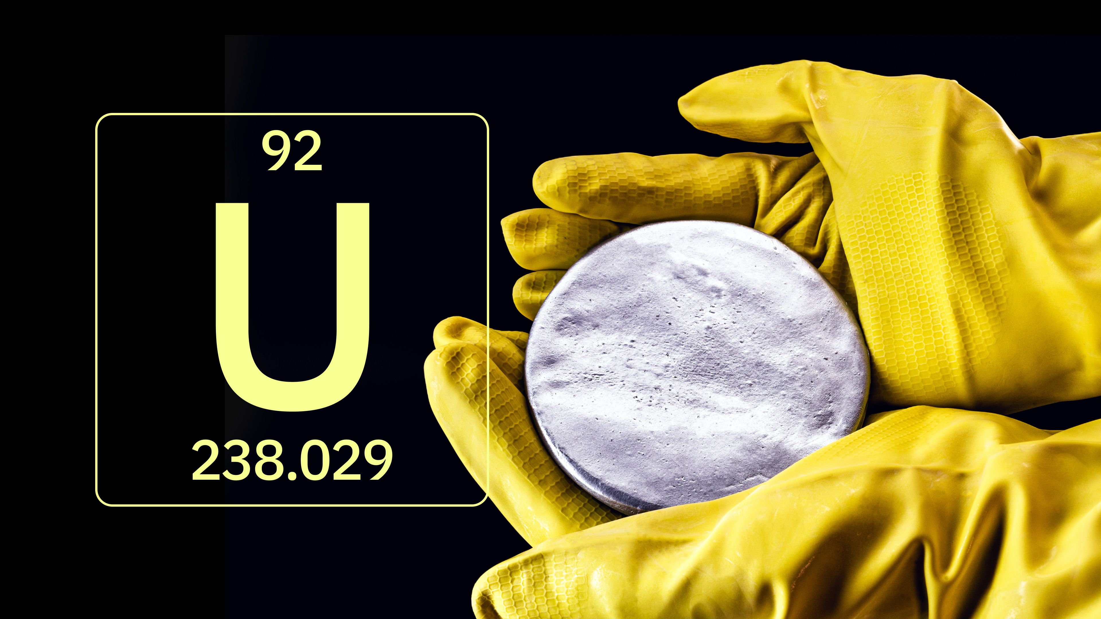 Atomic details of uranium and hands wearing yellow gloves holding a disk of uranium. 