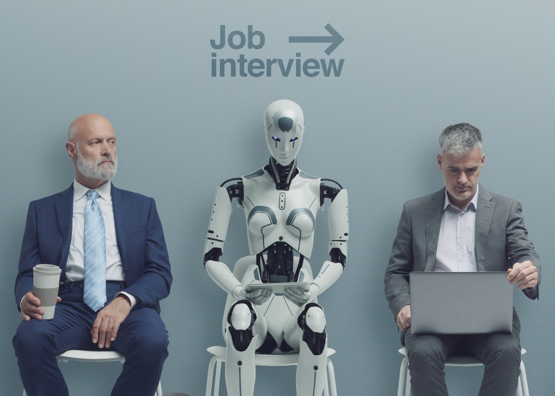 Two men sitting in line with a robot for a job interview
