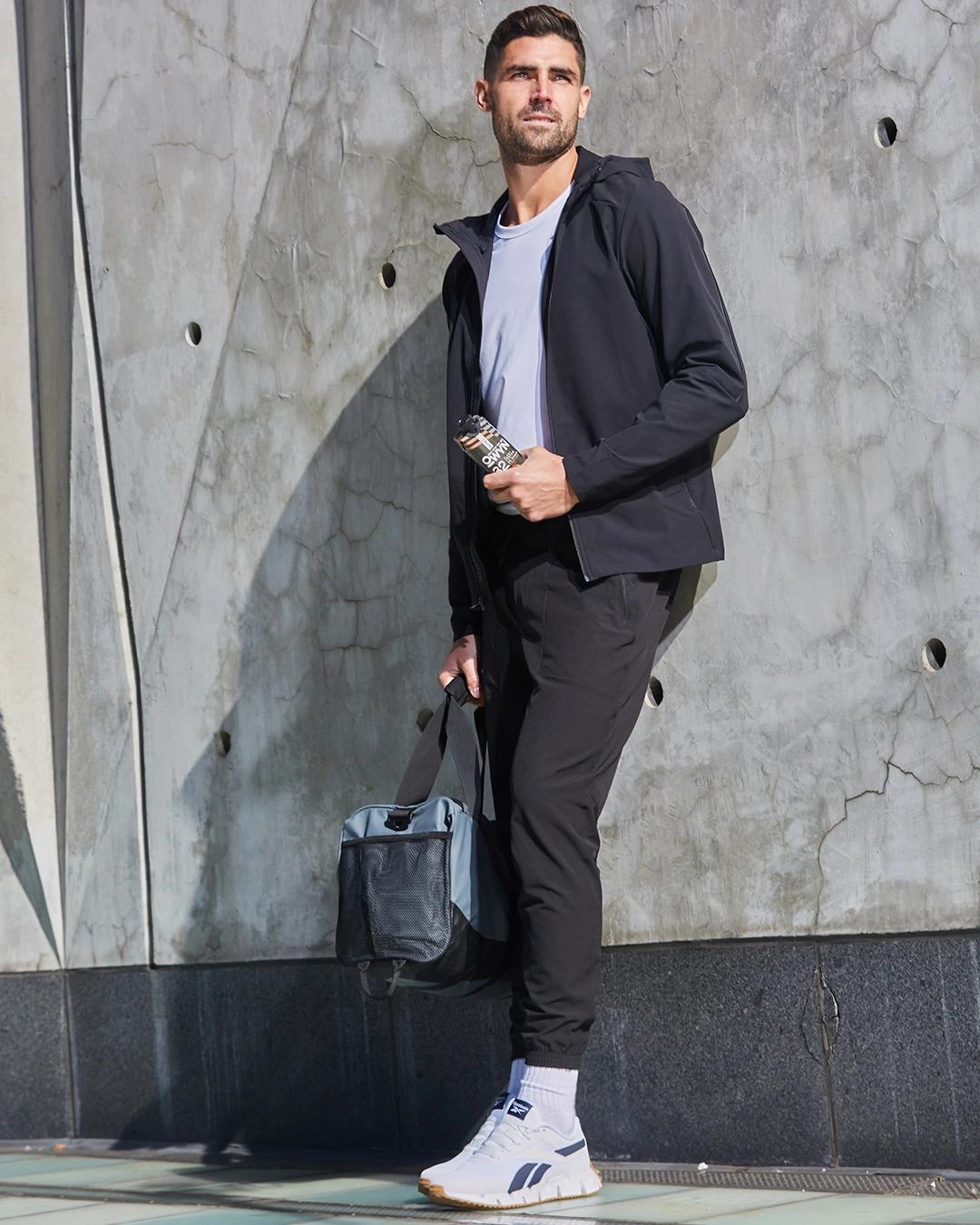 Man holding Pro Elite High Protein Shake Carton