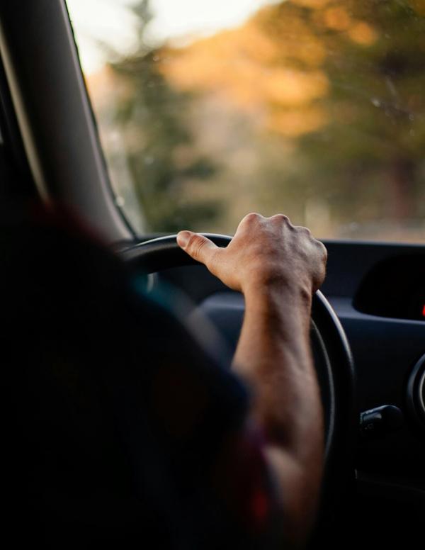 a hand on the steering wheel