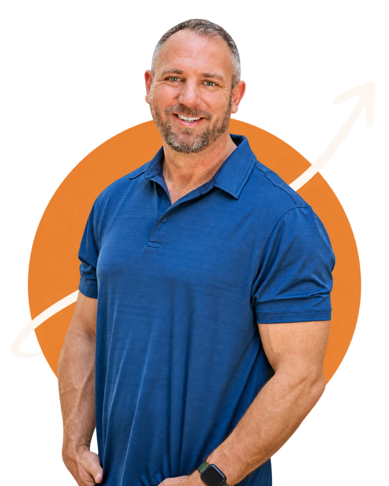 Shannon Herod smiling in a blue polo shirt, in front of an orange circle with a curving arrow rising behind him