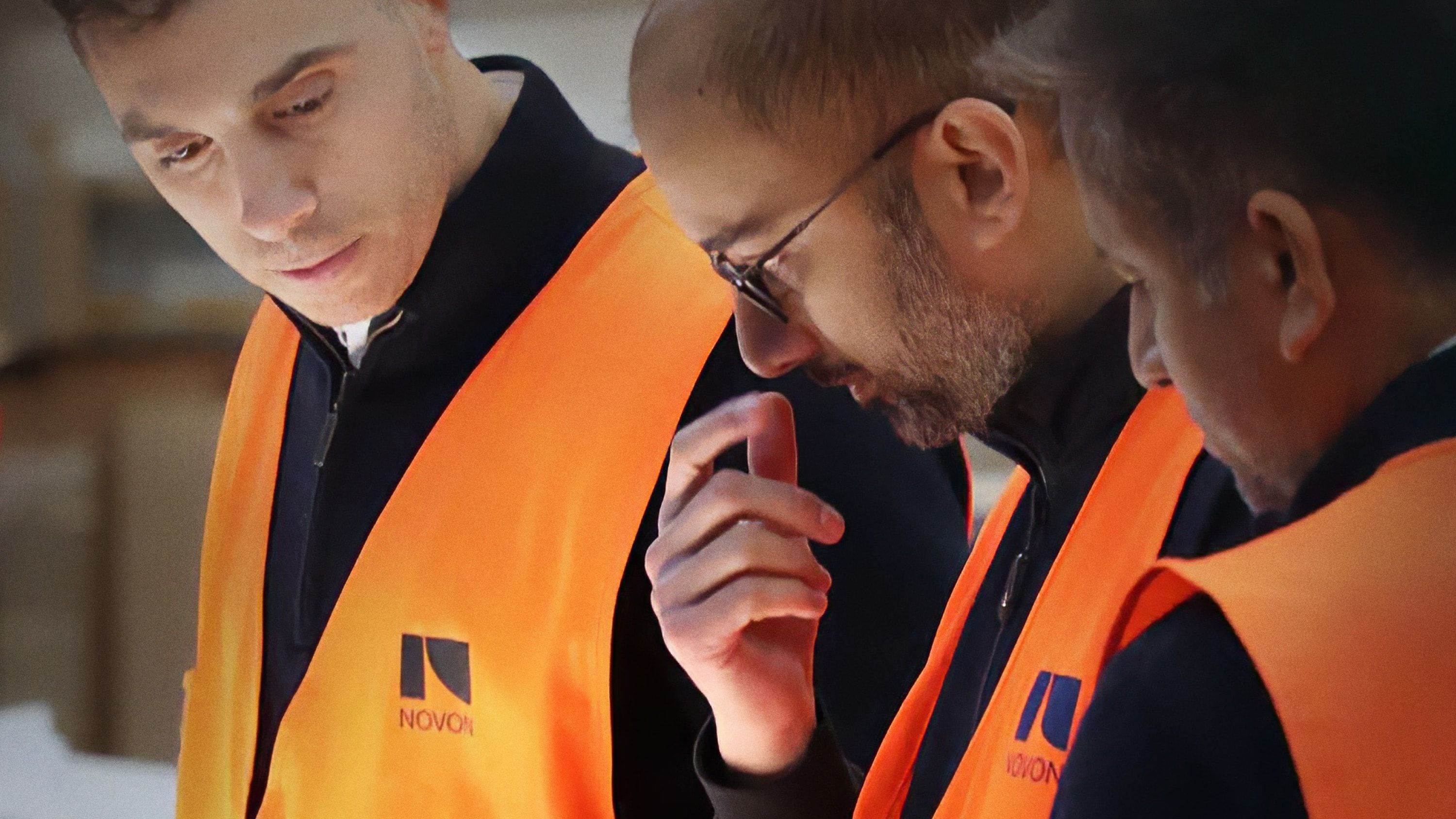 Workers wearing branded hi-vis vests.