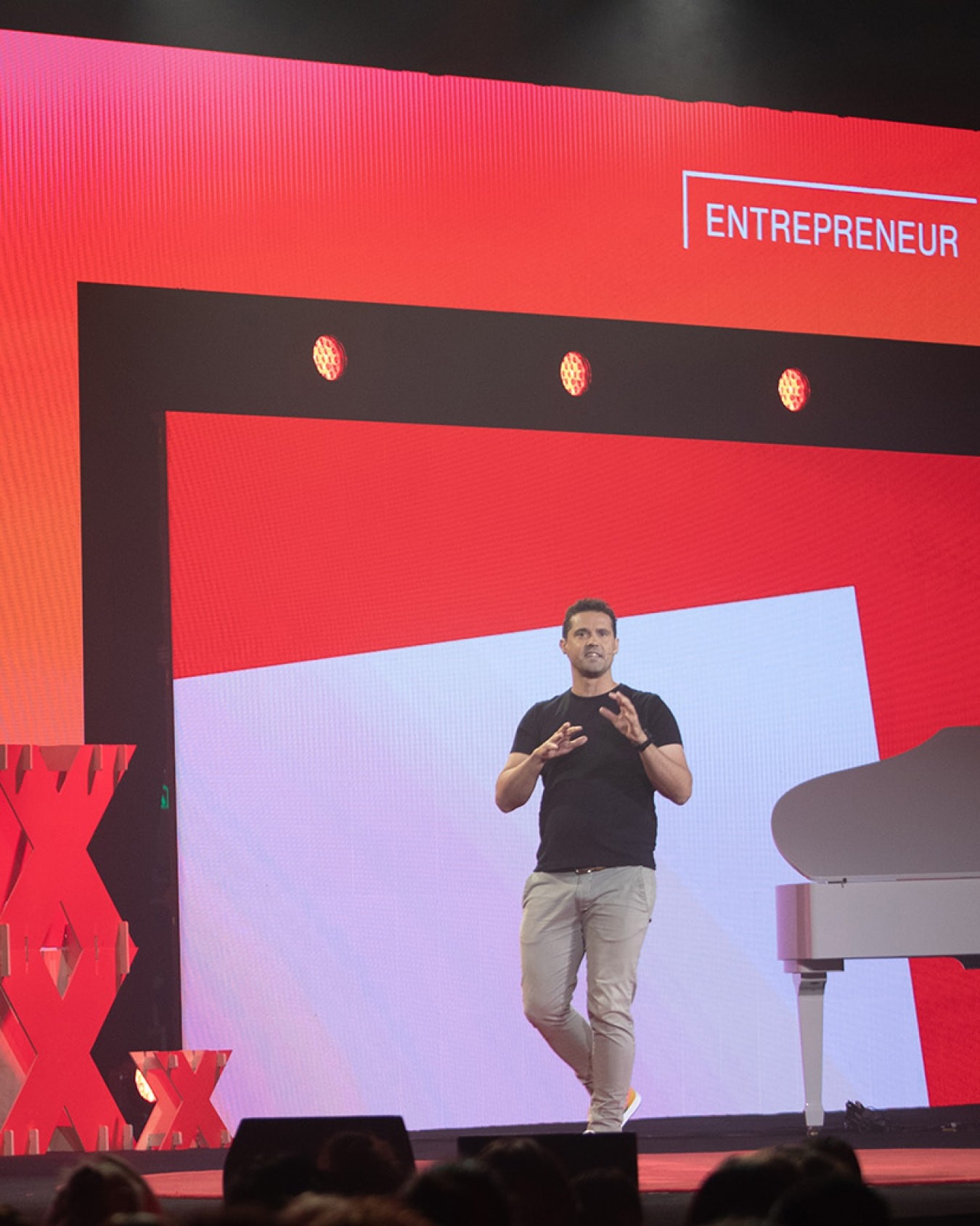 Speaker in front of screen graphics.