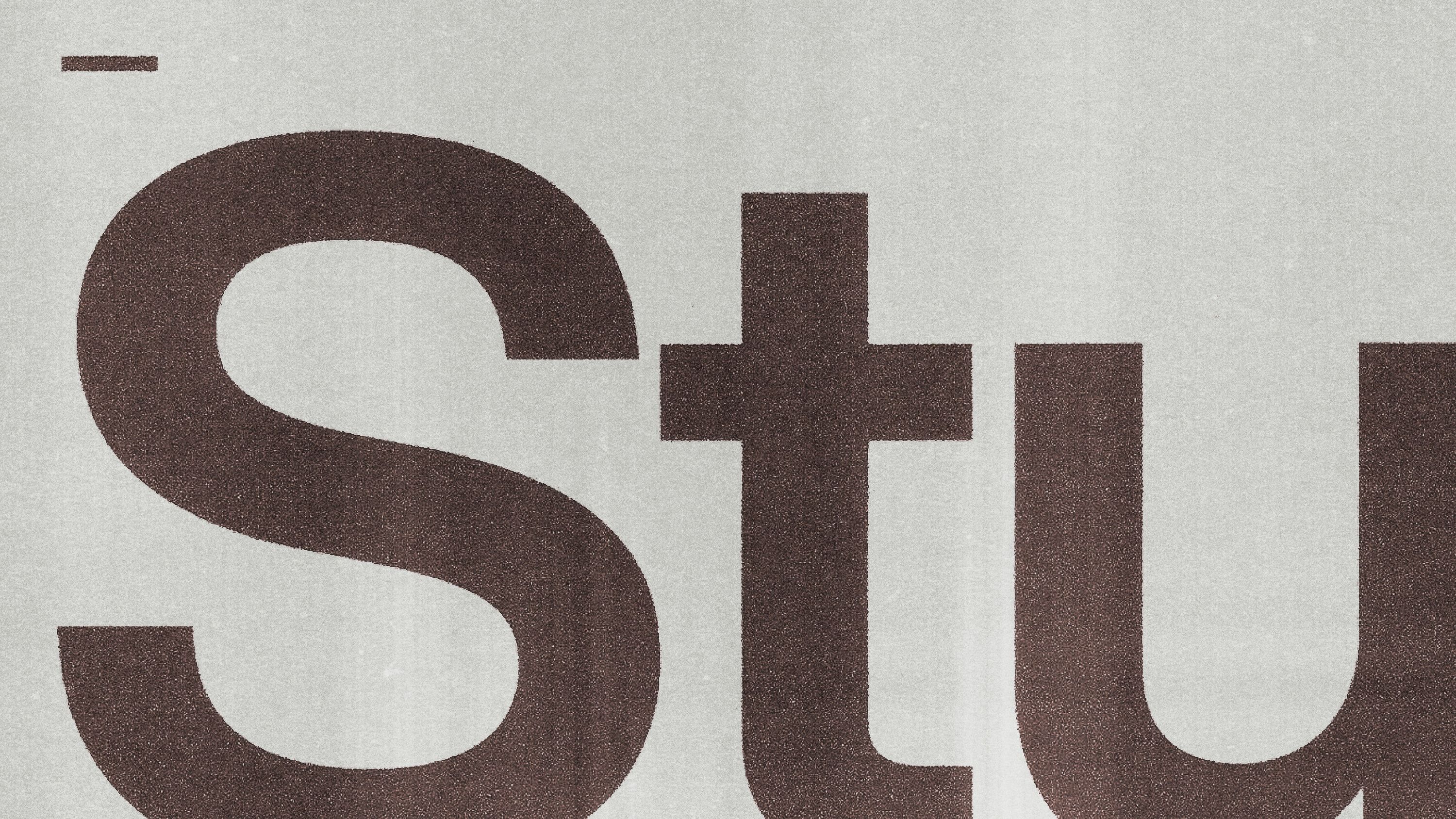 Close-up of Studio 44 logo showing enlarged sans-serif letterforms with a textured print finish.