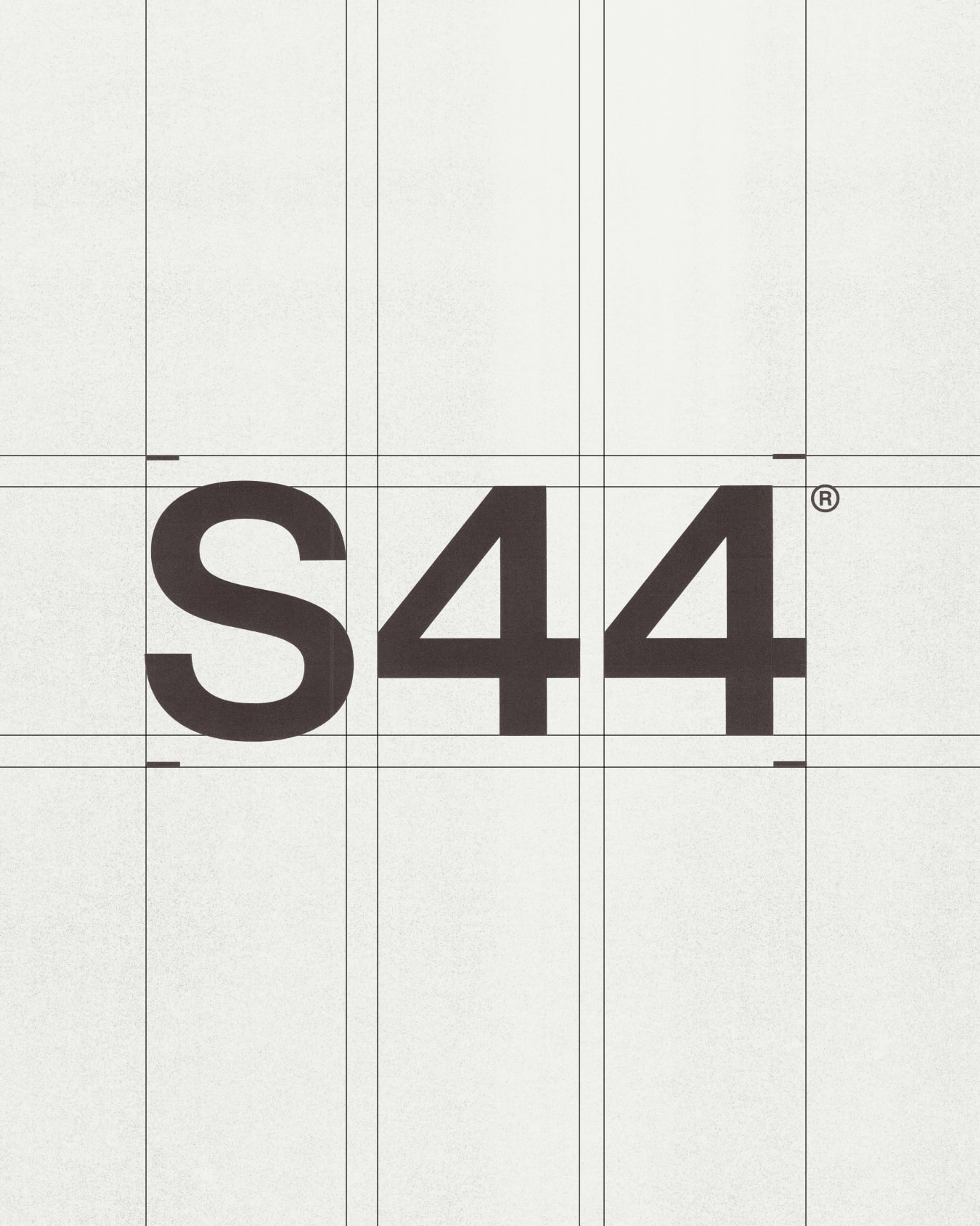 S44 wordmark set across a modular grid, framed with registration marks in each corner of the logo.