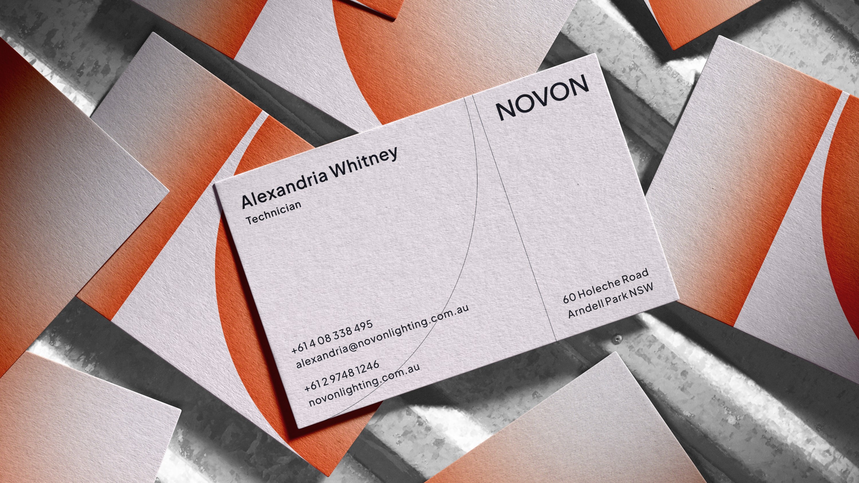 Front of business card on top of an array of business cards.