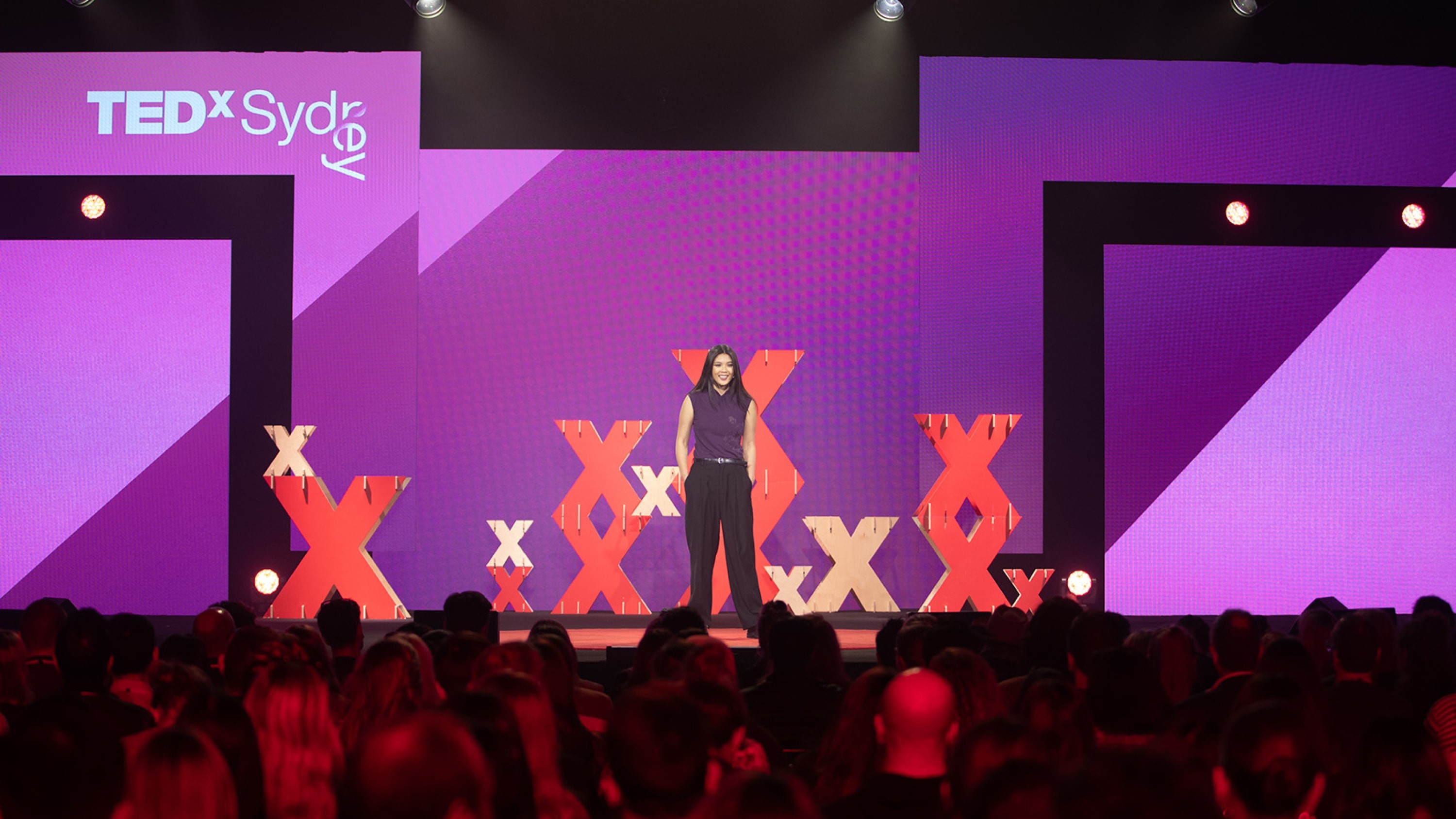 Host in front of screen graphics.