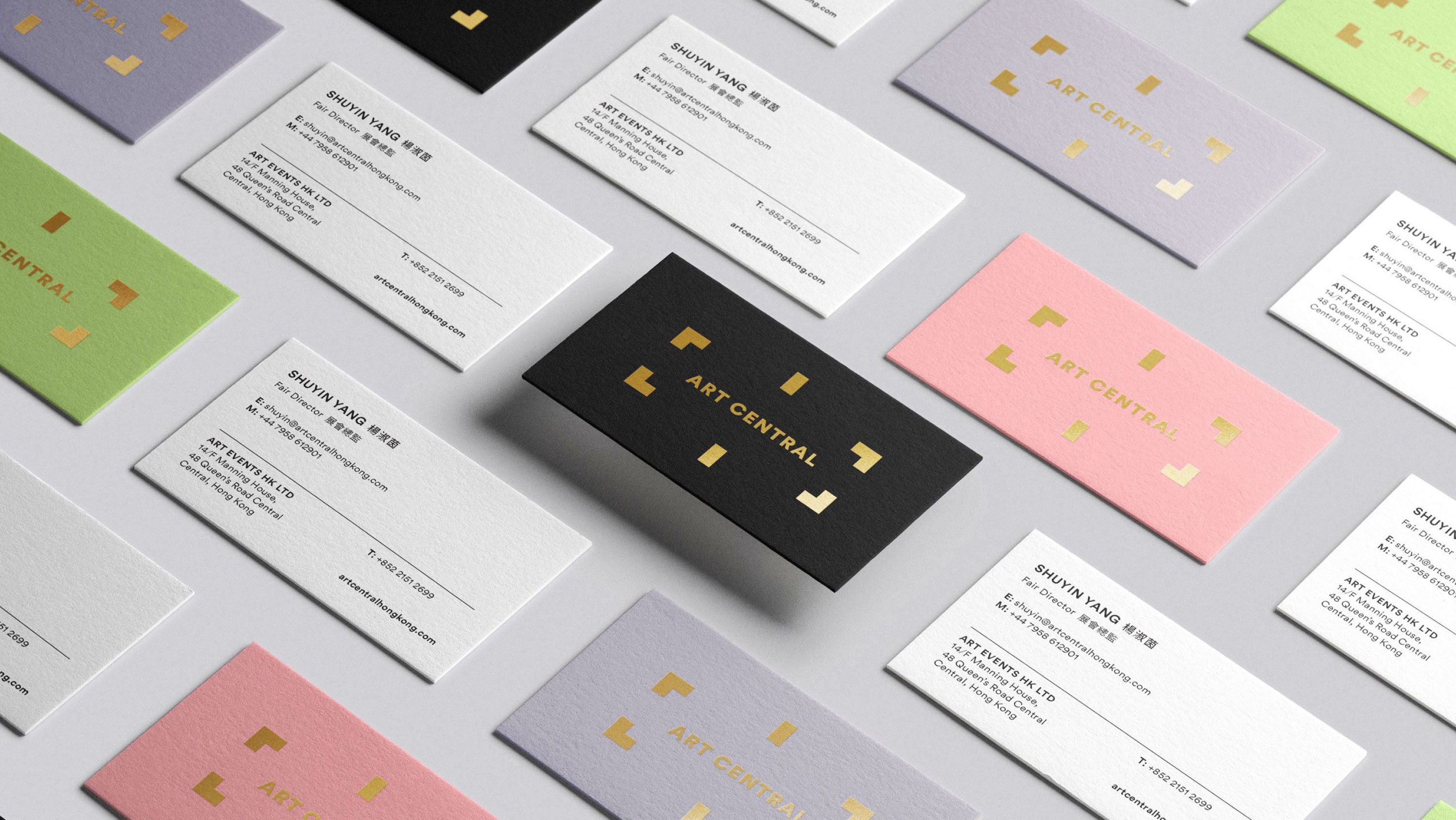 Business cards in multiple colours highlighting the foiled logo.
