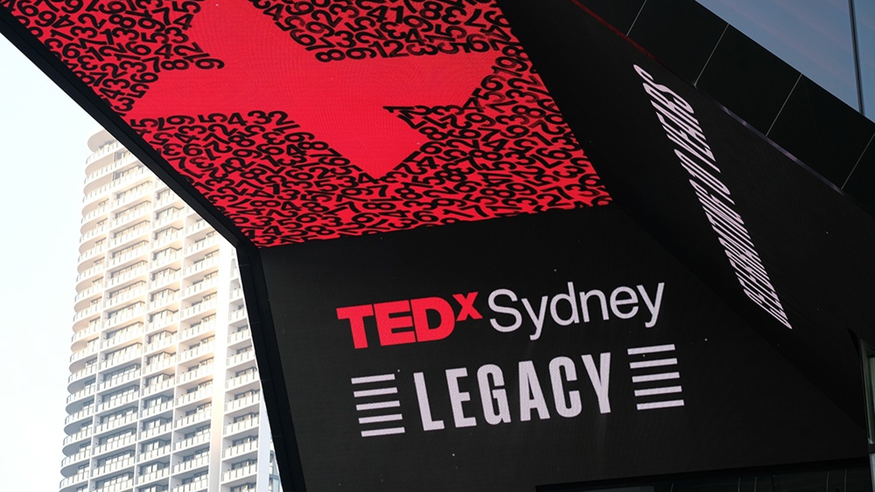 Close up of Out of Home screens at ICC Sydney showcasing the central graphic, logo and event name.