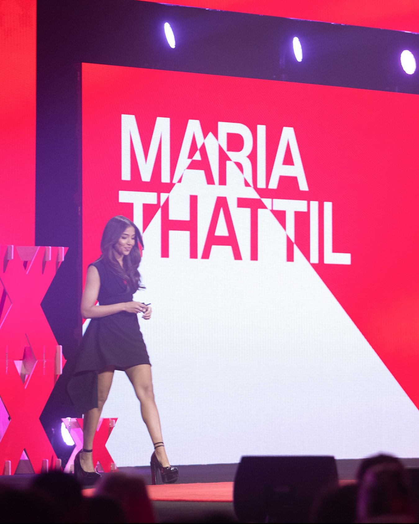 Speaker in front of screen graphics.