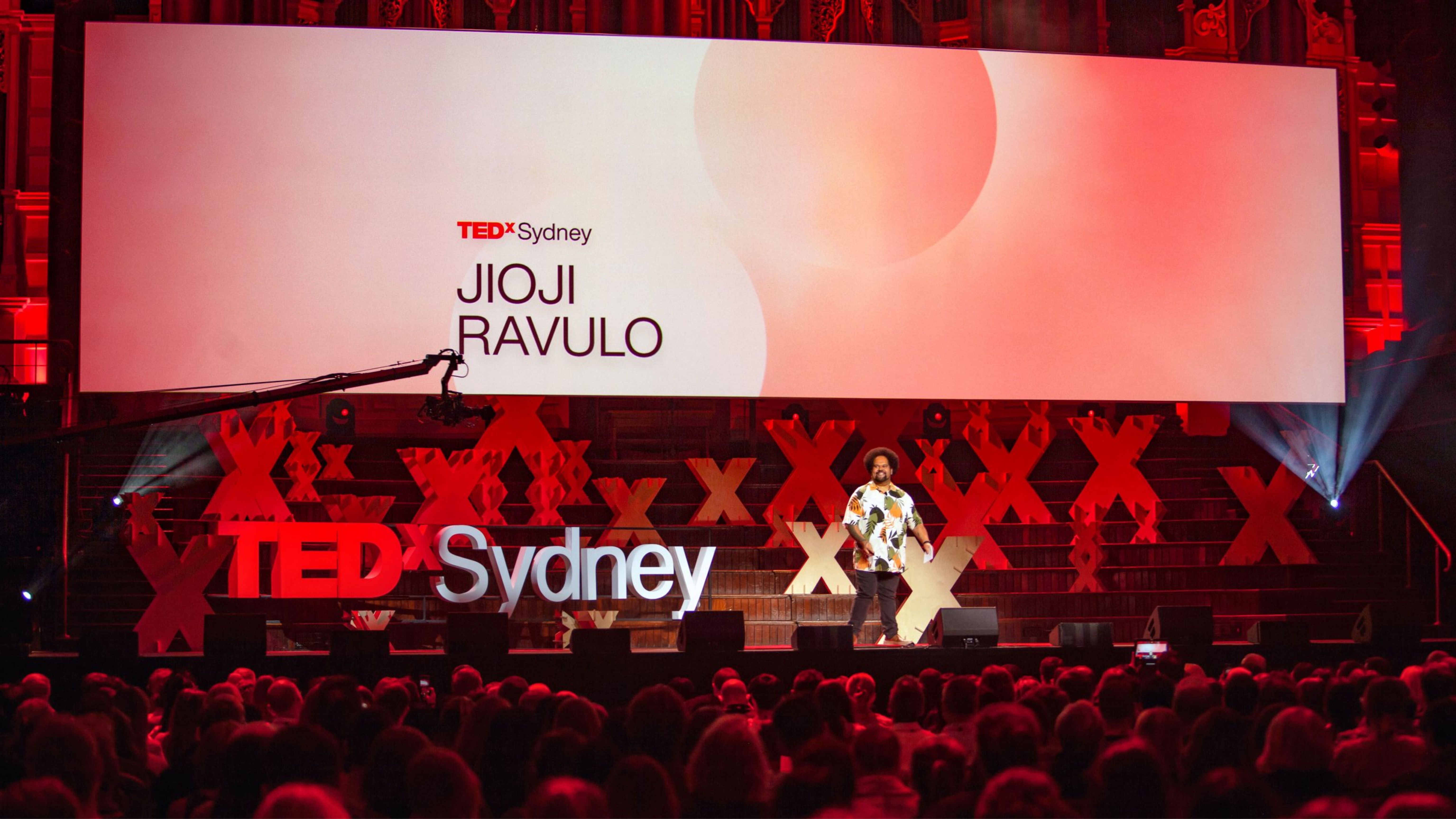 Speaker in front of screen graphics.