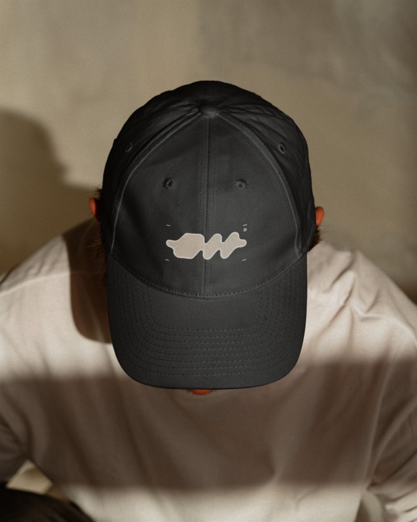 Mockup: A cap featuring one of the abstracted versions of the logomark.