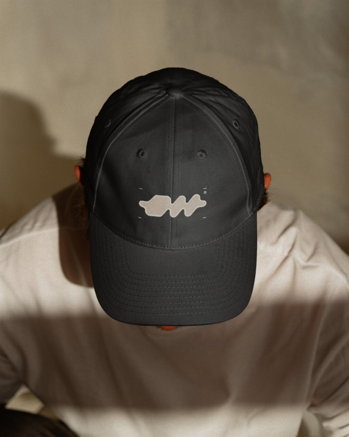 Mockup: A cap featuring one of the abstracted versions of the logomark.