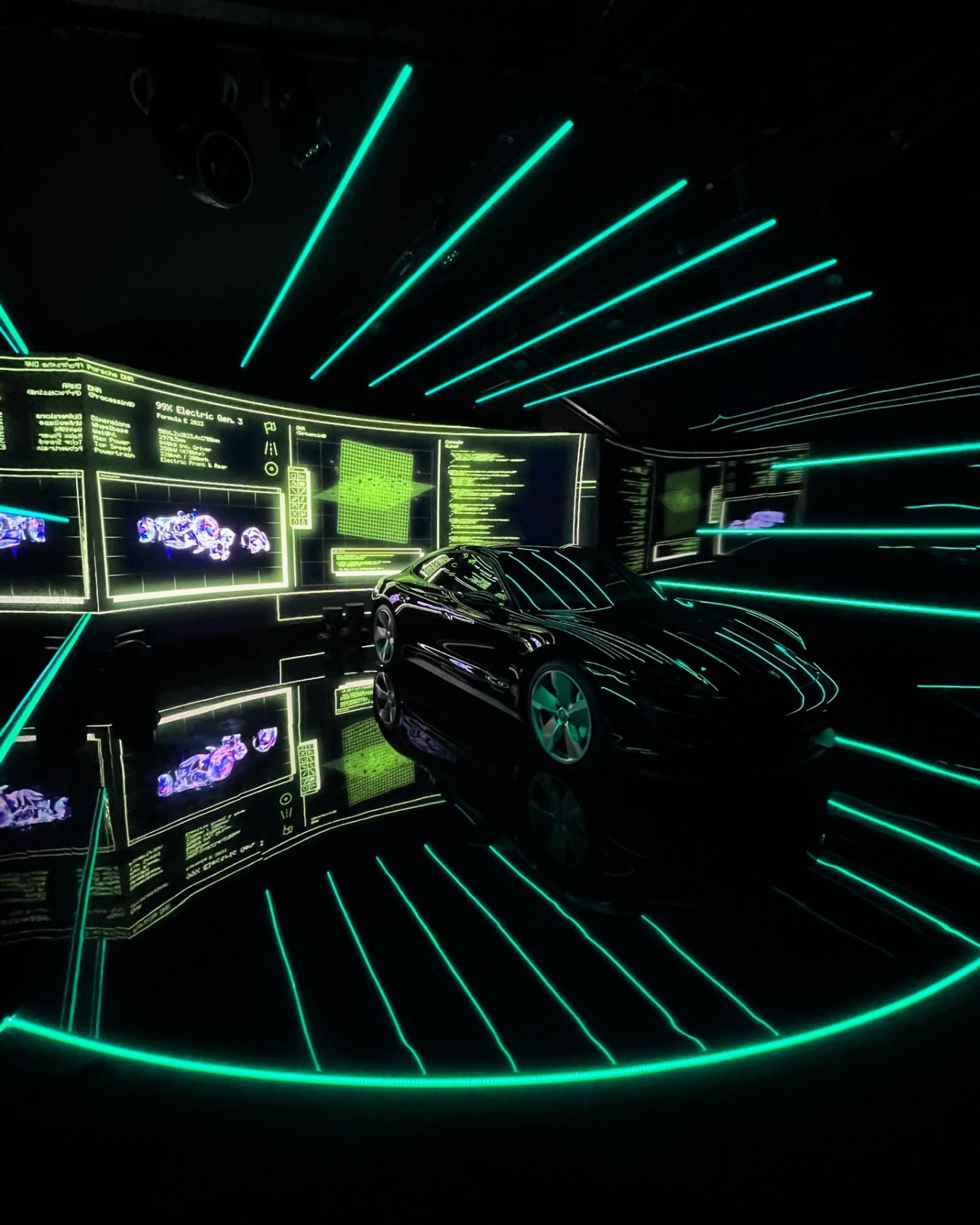 The Taycan with a cyberpunk-inspired infographic on the back screen and green vertical ceiling lights.
