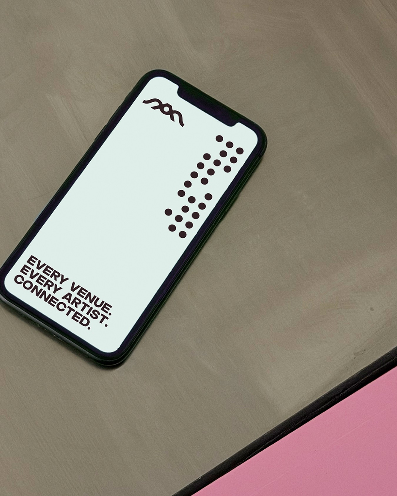 Phone displaying AMTN branding and “Every venue. Every artist. Connected.”