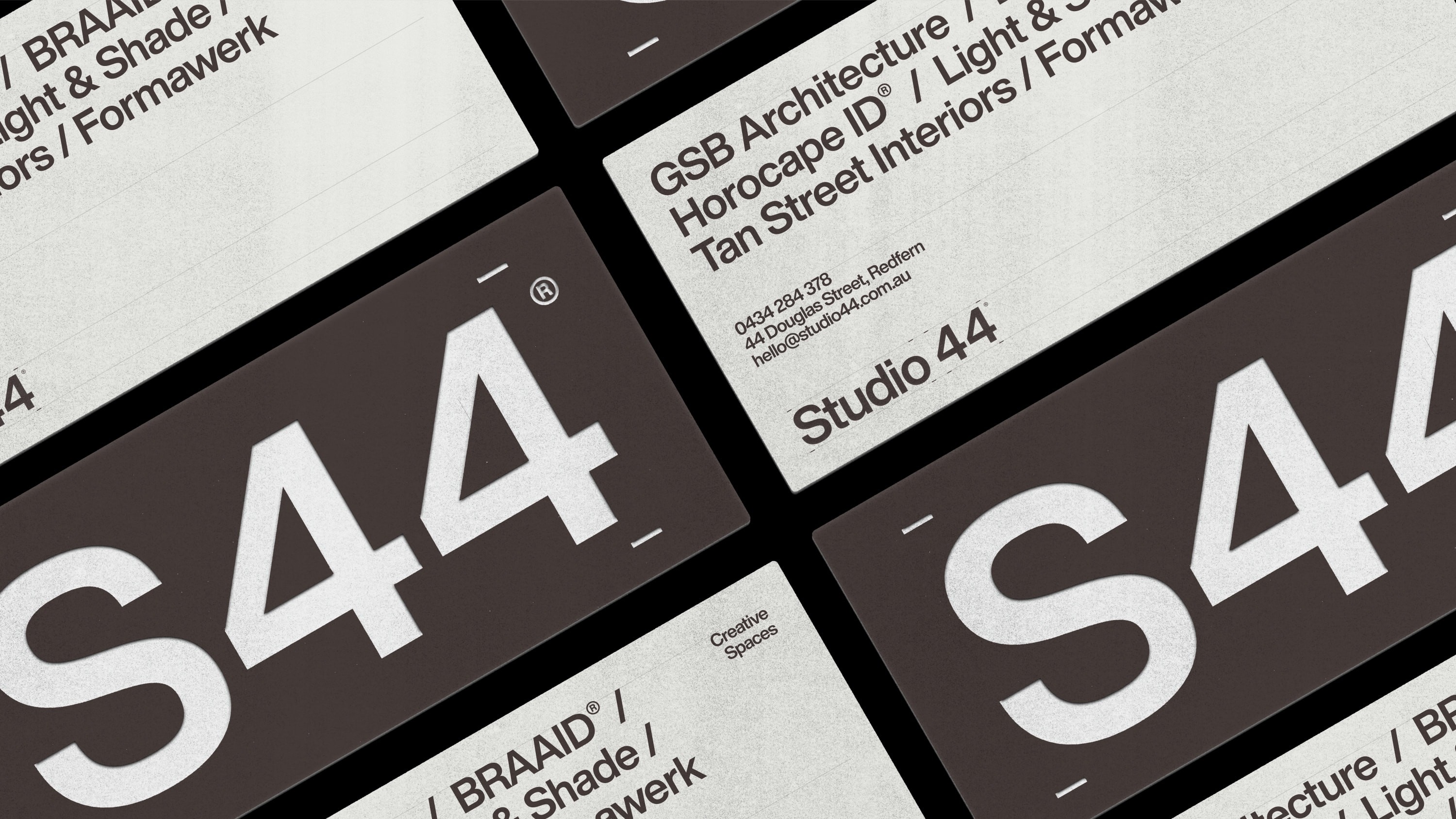 Studio 44 business cards showing the S44 wordmark with exposed layout gridlines.