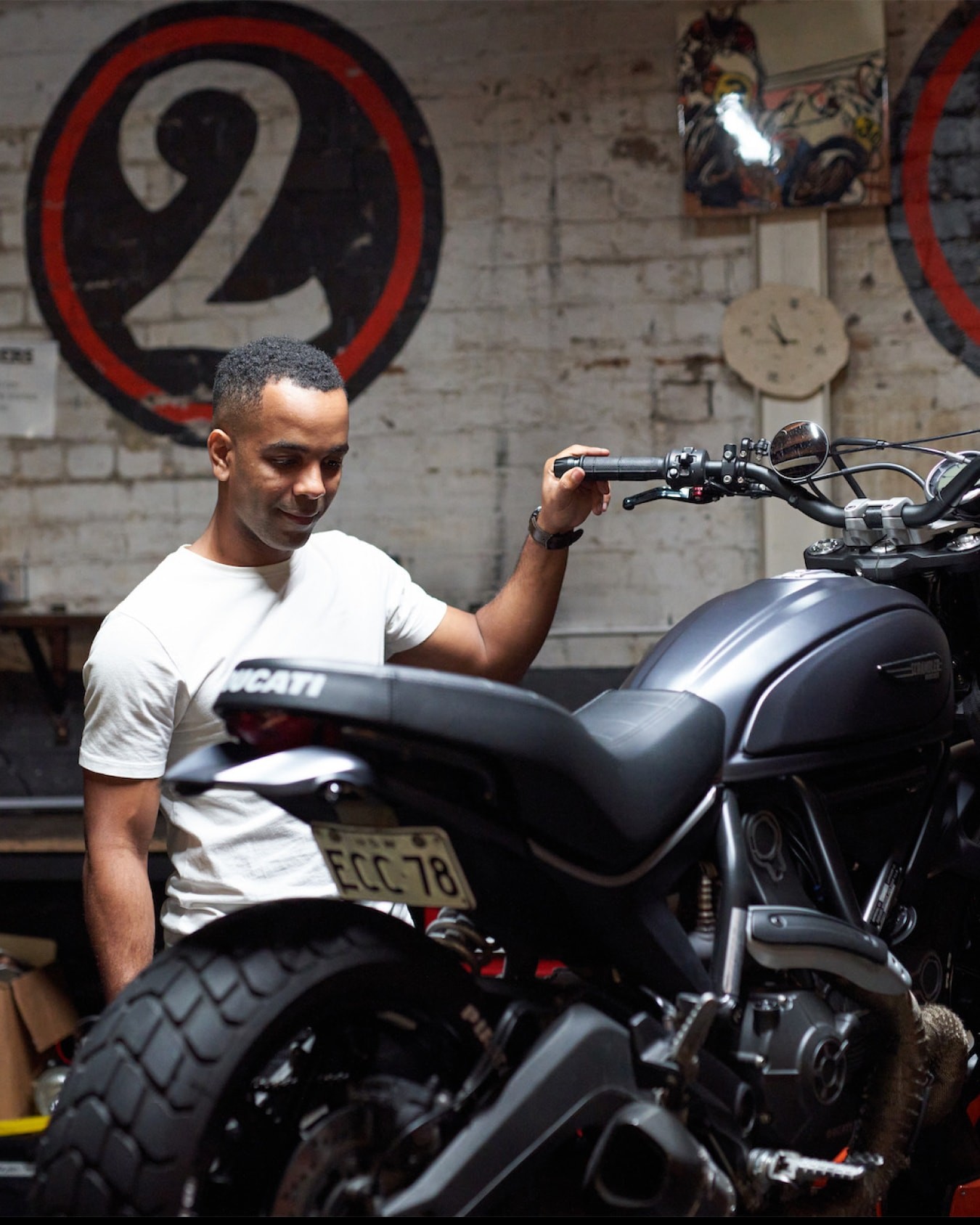 Talent looking at motorbike.