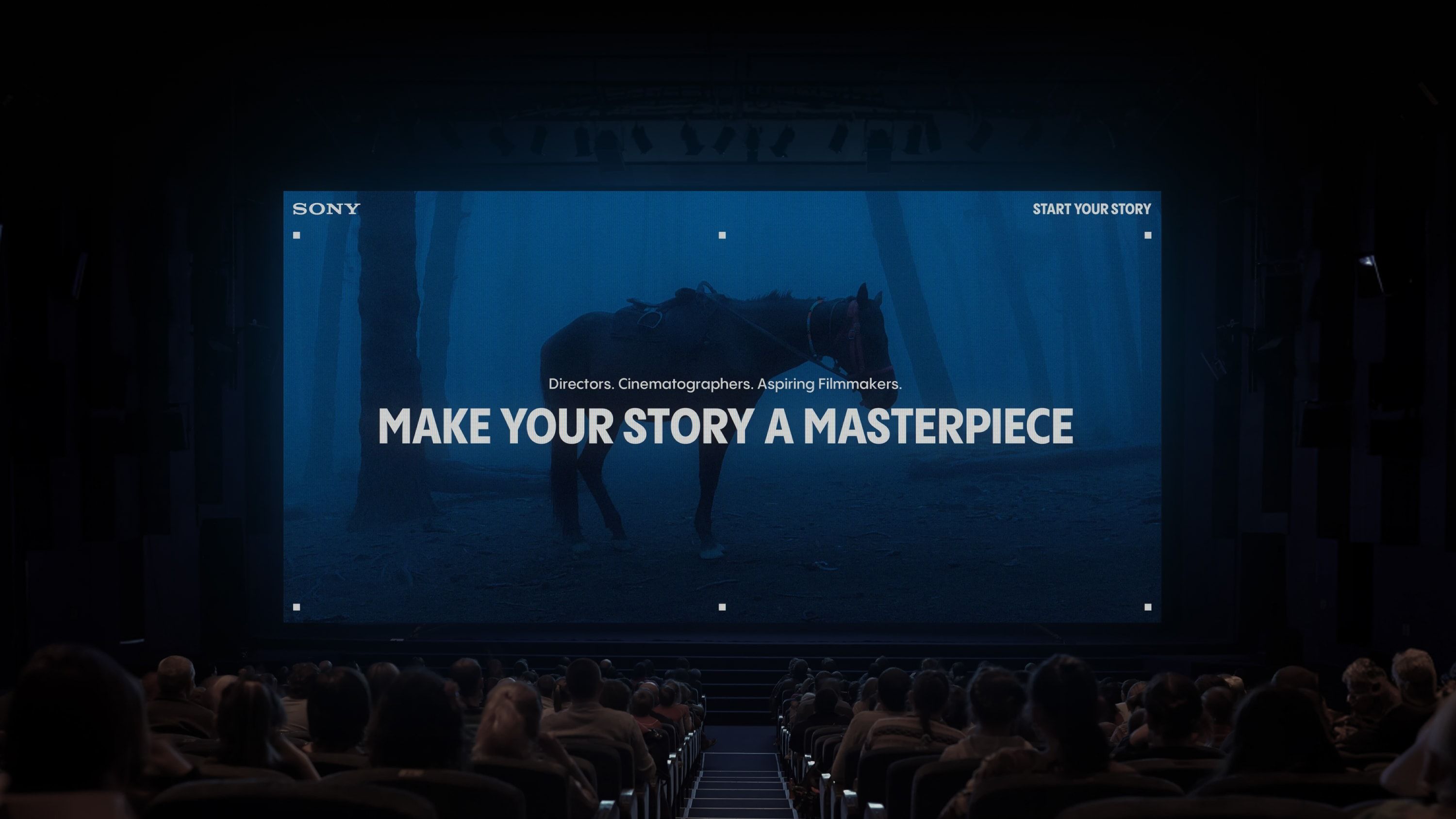 Large screen in front of crowd showcasing branding with heading ‘Make your story a masterpiece’.