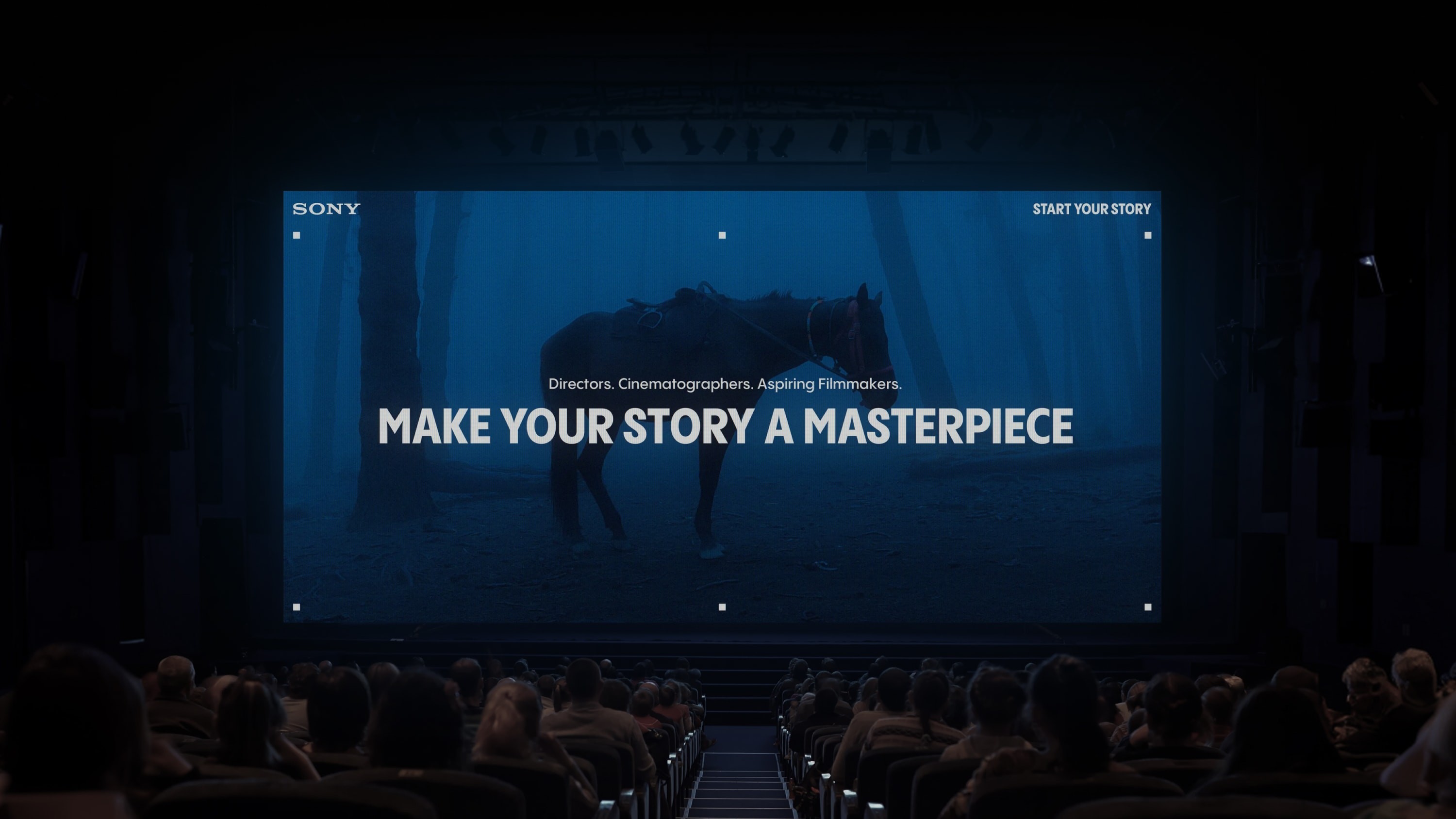 Large screen in front of crowd showcasing branding with heading ‘Make your story a masterpiece’.