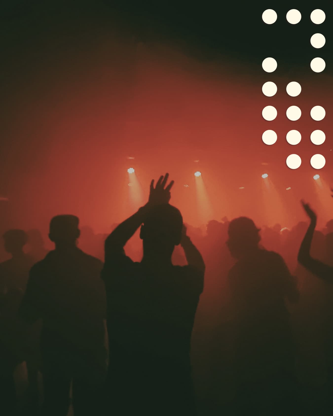 Concert audience under red lighting, with cream circles in one corner.