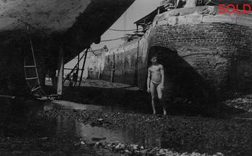 Boy under beached ship hull III [P11]