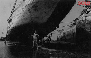 Boy under beached ship hull II [P9]