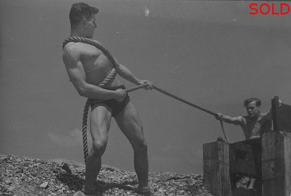 Two male figures posing at tug of war [P44]