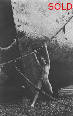 Male bather pulling on anchor chain [P36]