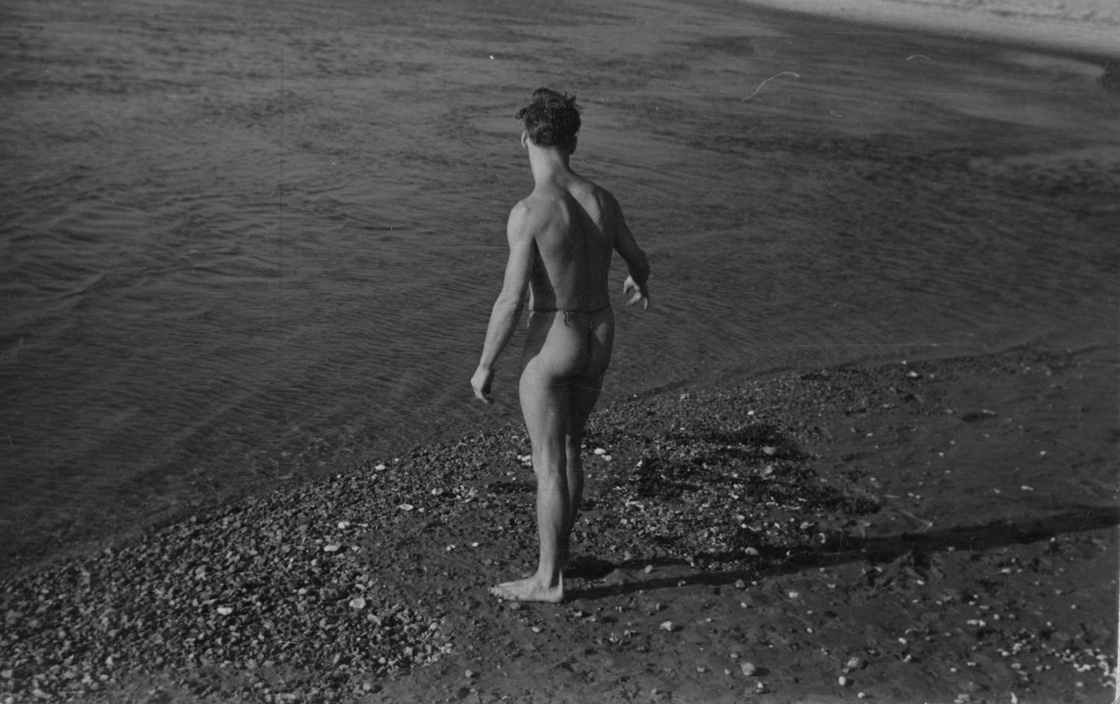 A male figure wearing loincloth standing at waters edge [P39]