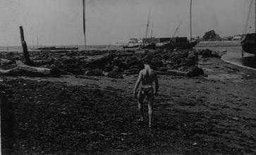 A male figure walking down the beach [P47]