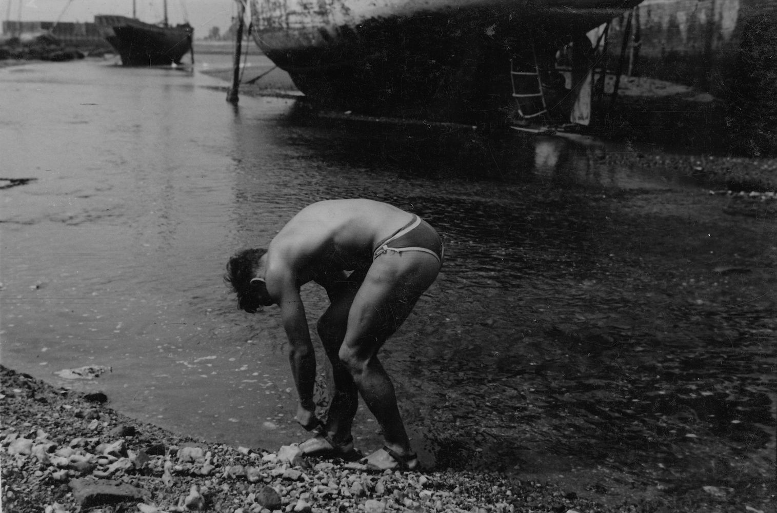 Male figure crouching at water’s edge [P52]
