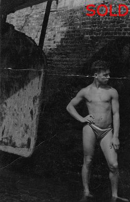 Male figure beside harbour wall (cut down) [P29]