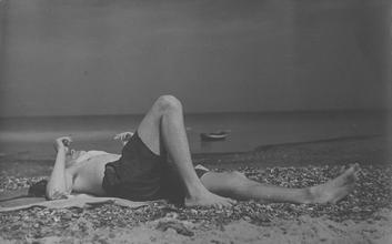 Male figure in bathing shorts lying on towel [P55]