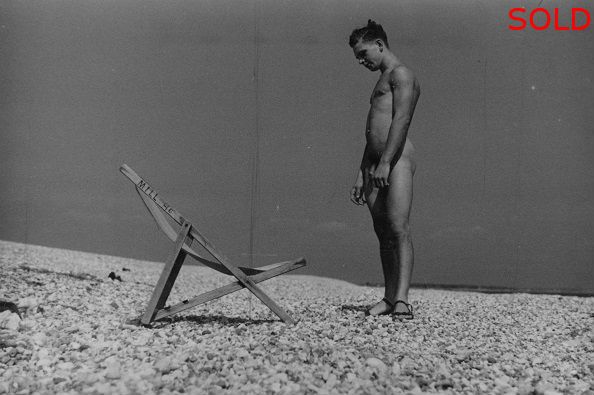 Male nude standing beside deck chair [P19]